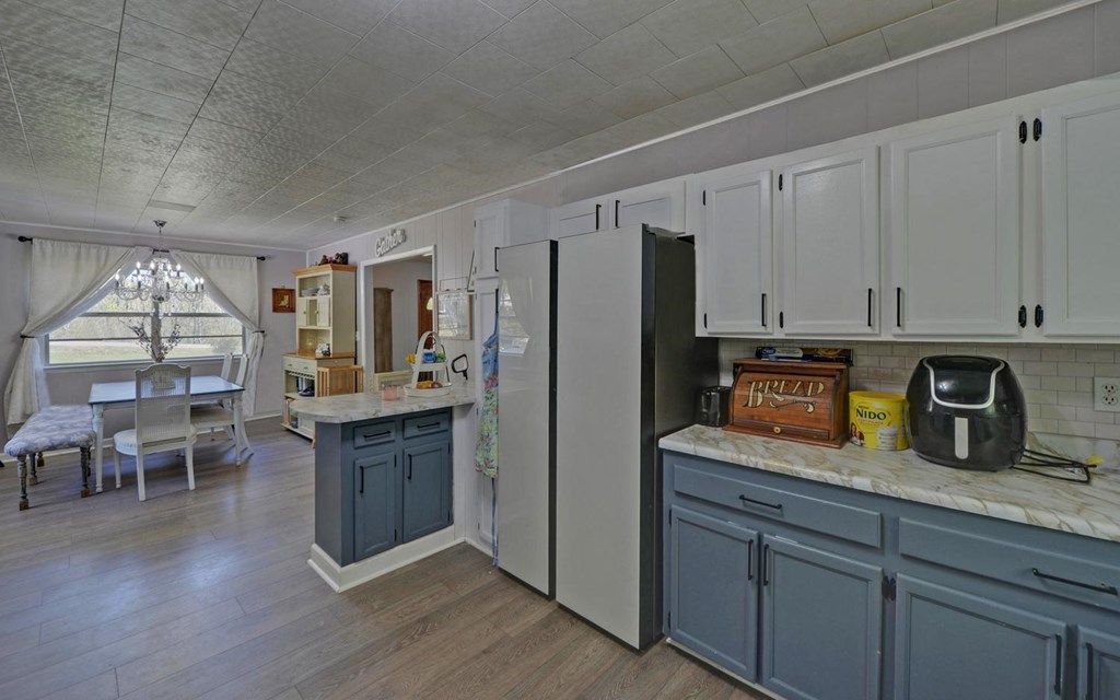 810 Grassy Creek Road Copperhill, TN 37317 - Photo 6 of 33 a kitchen with granite countertop cabinets a center island stainless steel appliances and cabinets