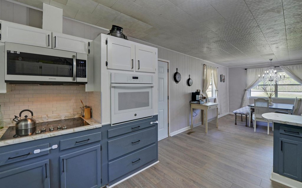 810 Grassy Creek Road Copperhill, TN 37317 - Photo 9 of 33 a kitchen with wooden cabinets and stainless steel appliances