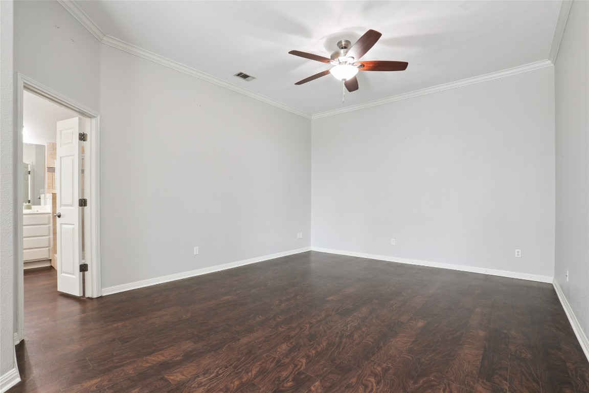 120 Juniper Trail Elgin, TX 78621 - Photo 13 of 32 Unfurnished room featuring dark wood-type flooring, ornamental molding, and ceiling fan