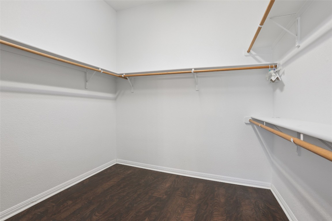 120 Juniper Trail Elgin, TX 78621 - Photo 16 of 32 Walk in closet with dark wood-style flooring