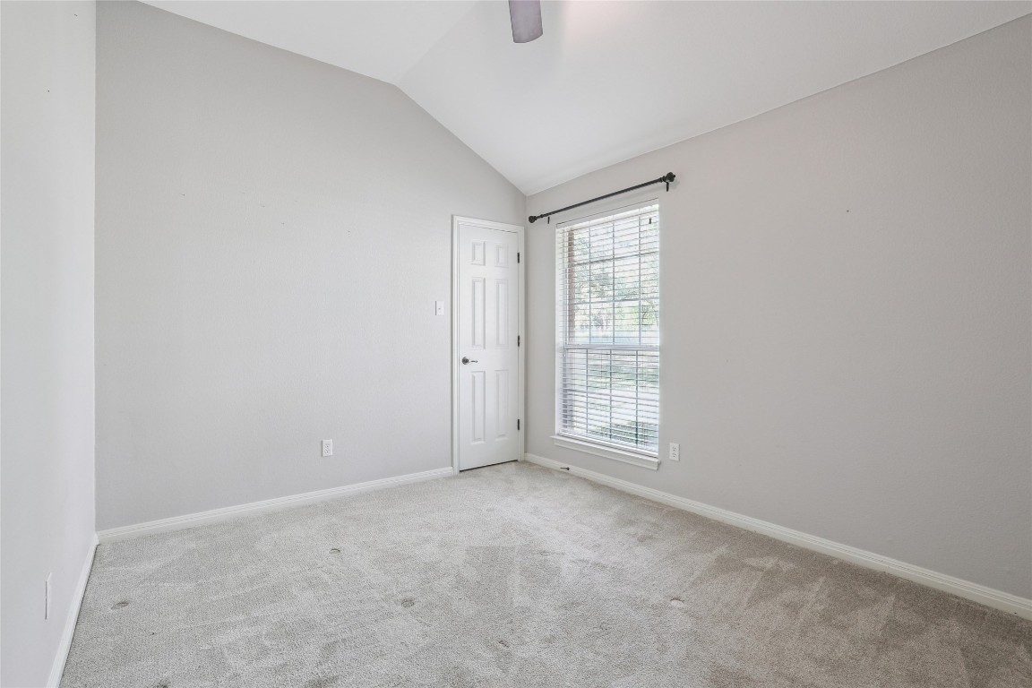 120 Juniper Trail Elgin, TX 78621 - Photo 17 of 32 Carpeted spare room featuring vaulted ceiling and ceiling fan
