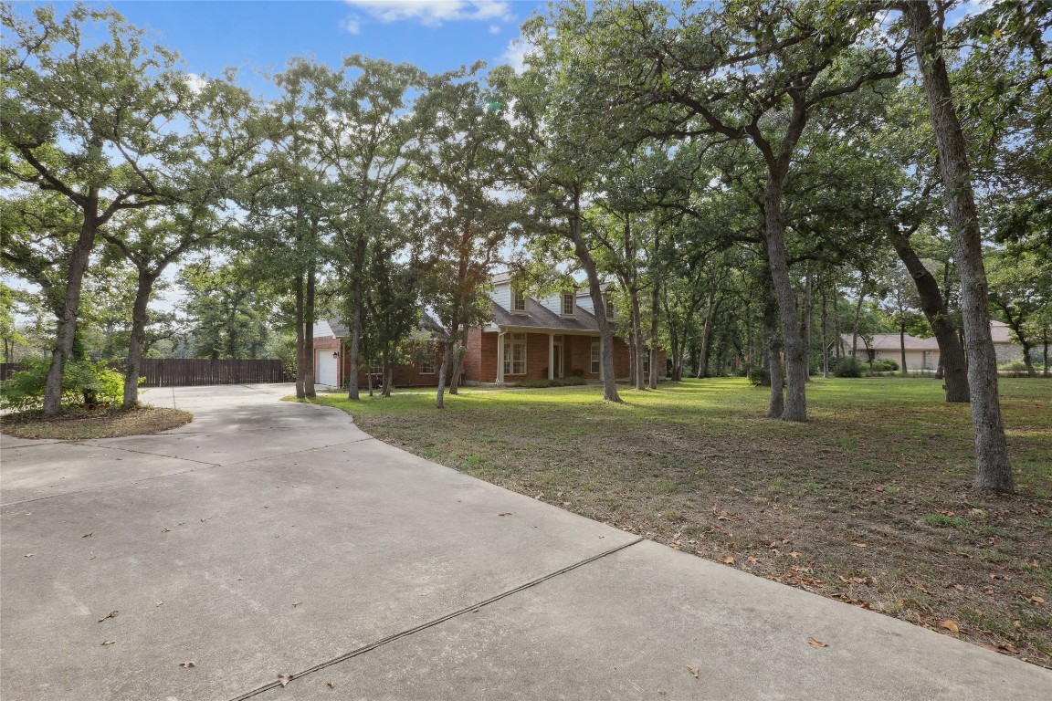 120 Juniper Trail Elgin, TX 78621 - Photo 2 of 32 View of front of property with driveway, brick siding, and an attached garage