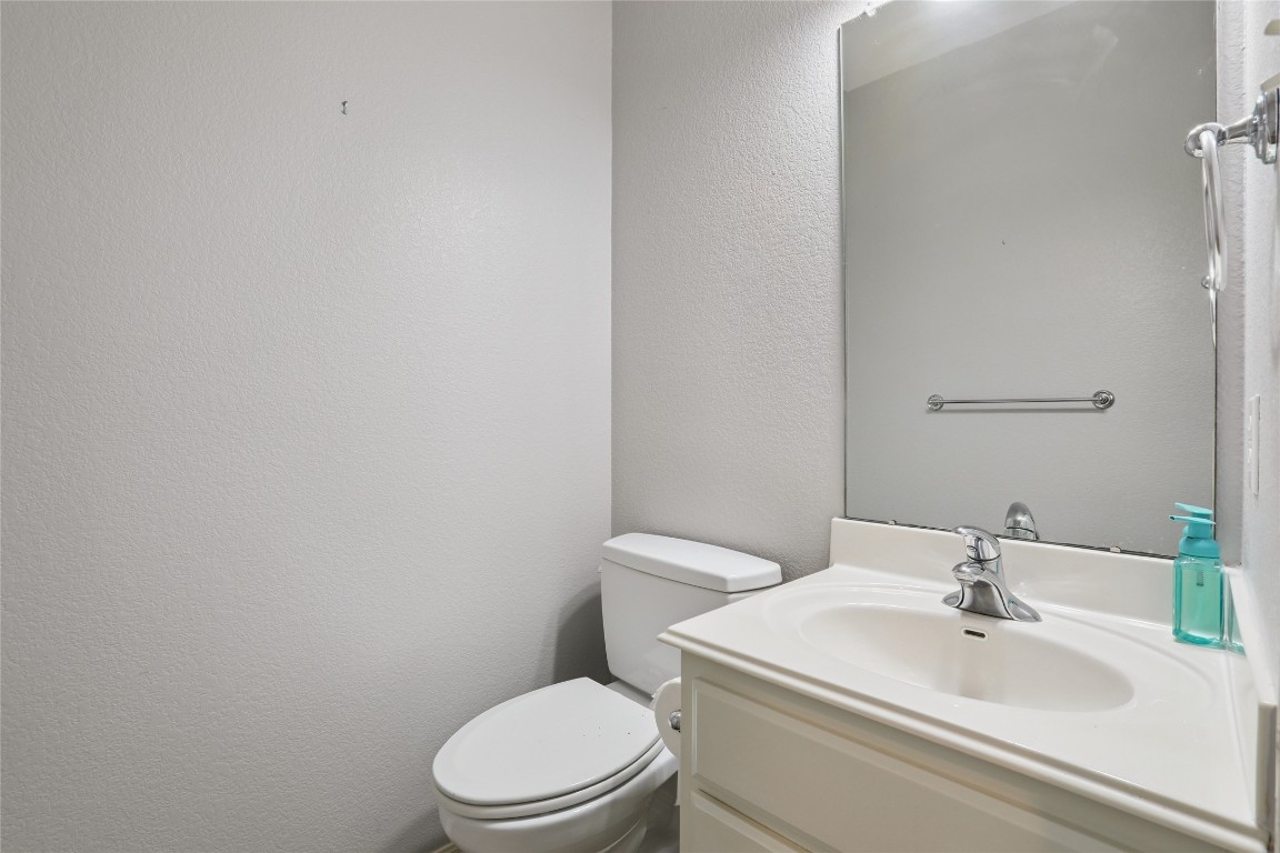 120 Juniper Trail Elgin, TX 78621 - Photo 23 of 32 Half bathroom featuring a textured wall and vanity