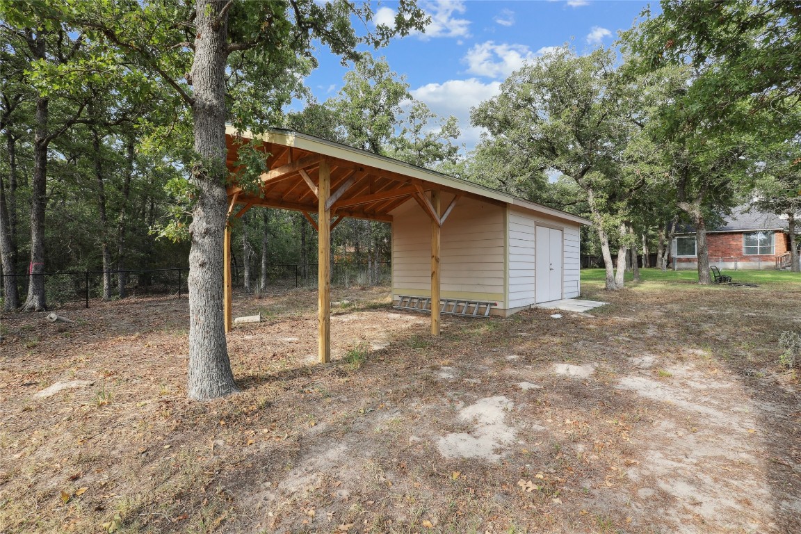 120 Juniper Trail Elgin, TX 78621 - Photo 31 of 32 View of yard featuring an outbuilding