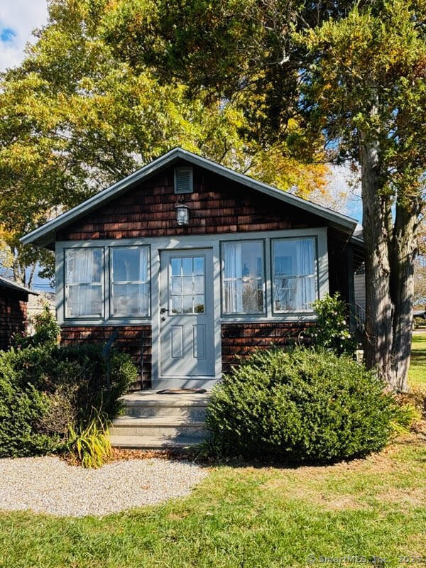 69 Waterside Lane, Unit 1 Clinton, CT 06413 - Photo 1 of 15 a front view of a house with a yard