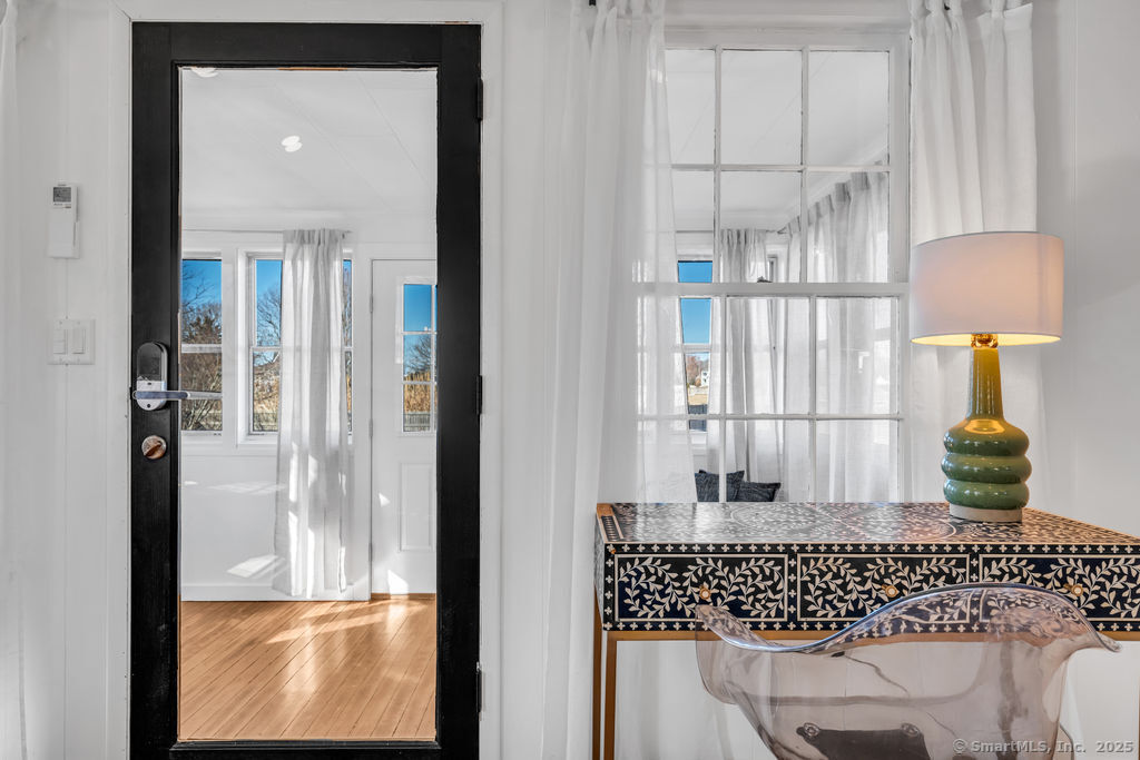 69 Waterside Lane, Unit 1 Clinton, CT 06413 - Photo 12 of 15 a window and a table in a balcony