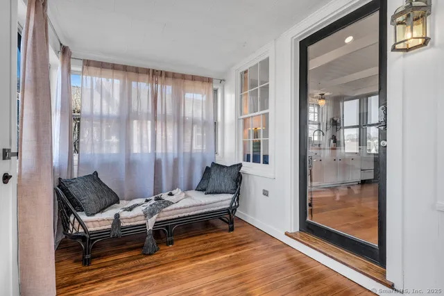 a living room with furniture and next to a window