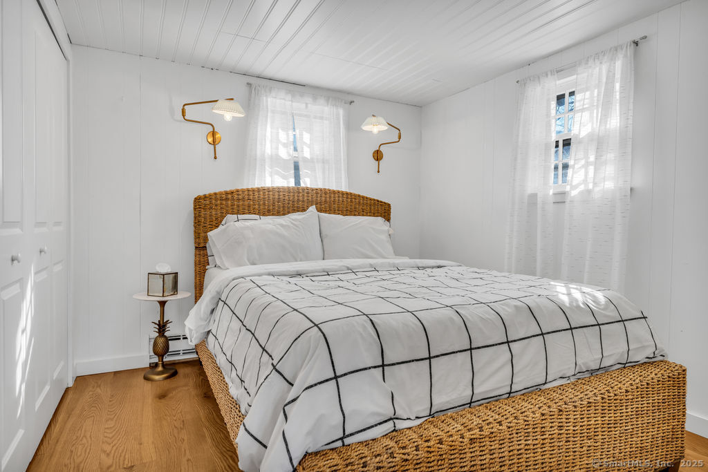 69 Waterside Lane, Unit 1 Clinton, CT 06413 - Photo 14 of 15 a bedroom with a bed and window