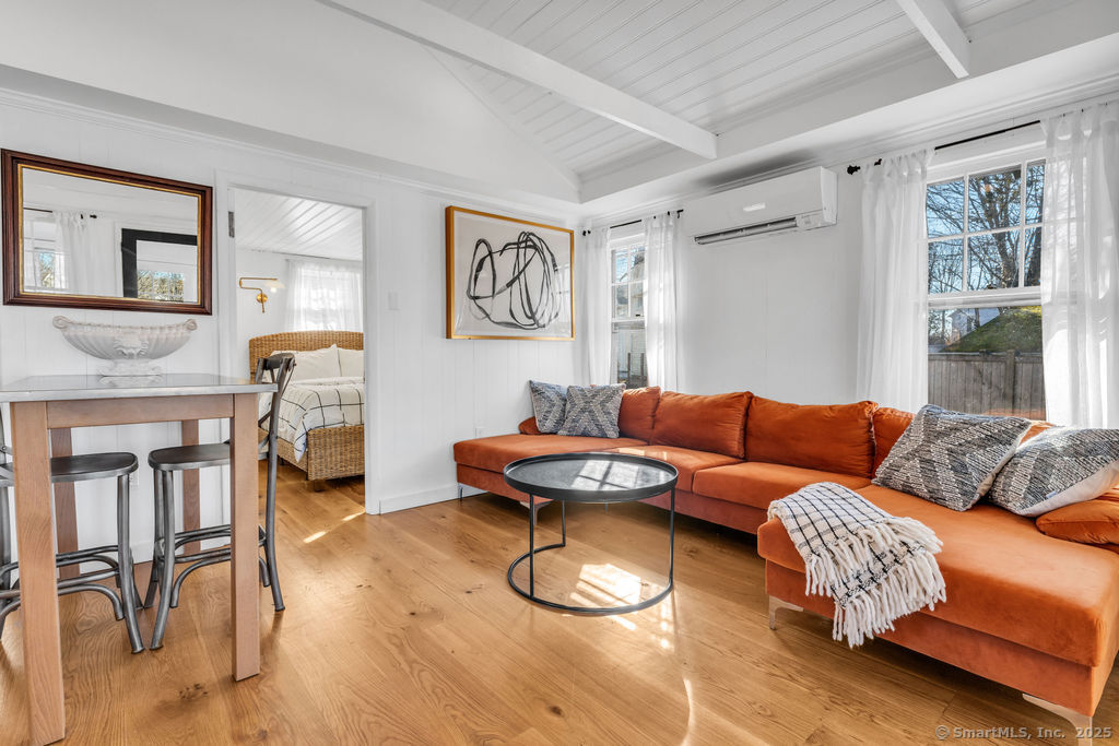69 Waterside Lane, Unit 1 Clinton, CT 06413 - Photo 2 of 15 a living room with furniture and a table