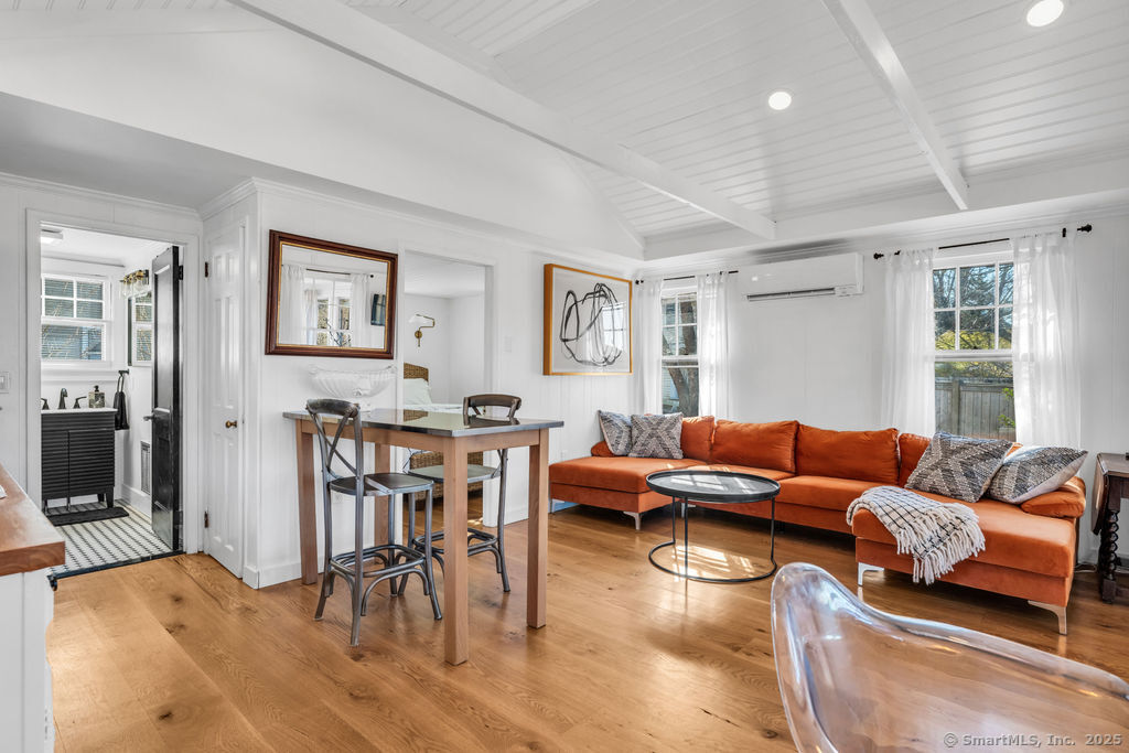 69 Waterside Lane, Unit 1 Clinton, CT 06413 - Photo 3 of 15 a living room with furniture wooden floor and dining table