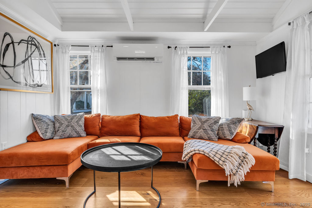 69 Waterside Lane, Unit 1 Clinton, CT 06413 - Photo 6 of 15 a living room with furniture and a flat screen tv