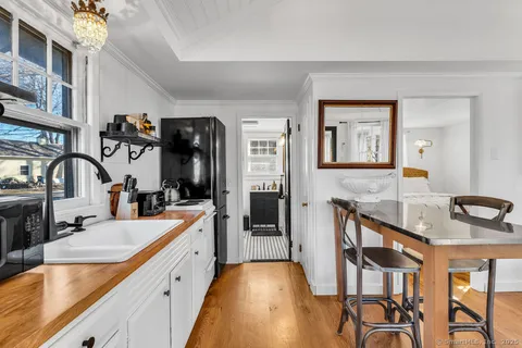 a large kitchen with a sink and cabinets