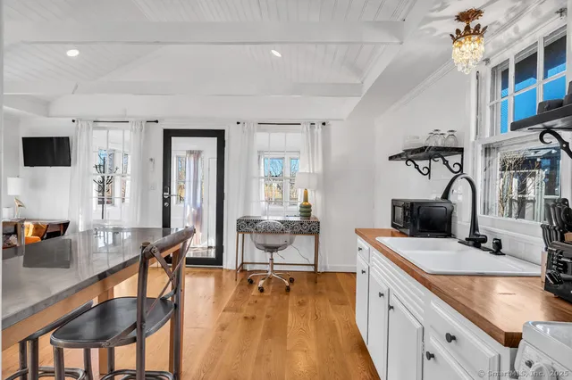 a kitchen with stainless steel appliances granite countertop a sink a stove and a refrigerator