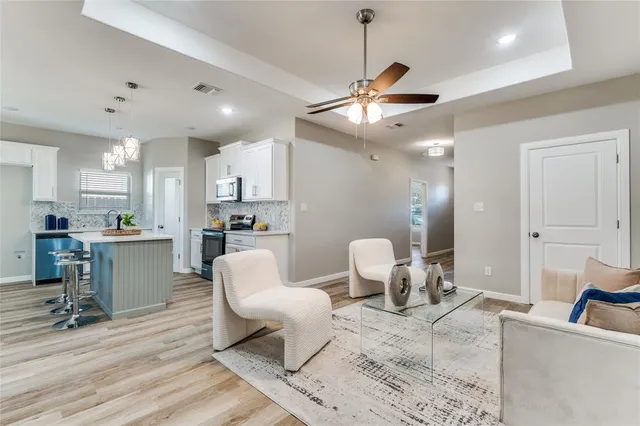 a living room with furniture and kitchen view