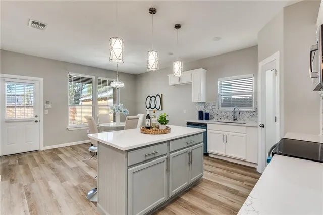 a kitchen with a sink stove and cabinets