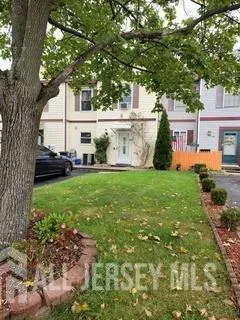 a view of house with backyard