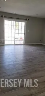 a view of wooden floor and cabinet in a room
