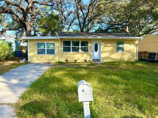 a front view of a house with a yard porch and outdoor seating