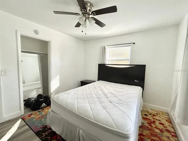 a bedroom with a bed and a window