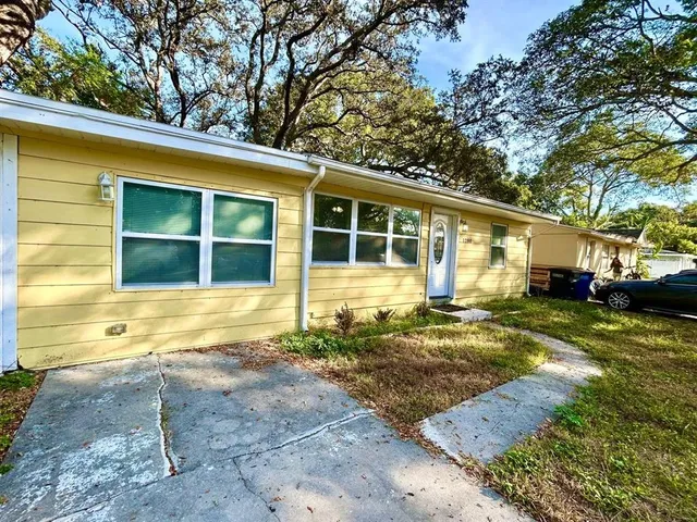 a view of a house with backyard and sitting area