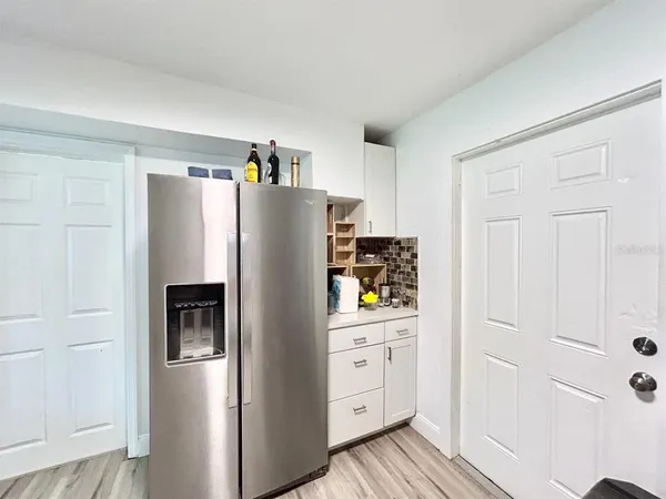 a kitchen with stainless steel appliances a refrigerator and a cabinets