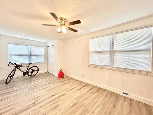 a view of a room with window and a wooden floor