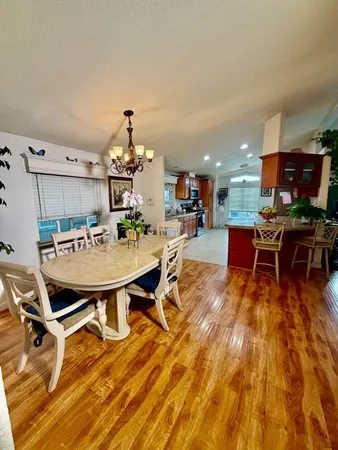 a living room with dining room and kitchen view