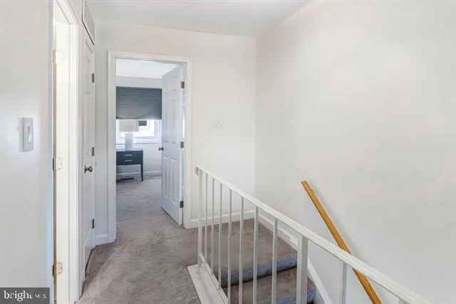 a view of a hallway with wooden floor and entryway