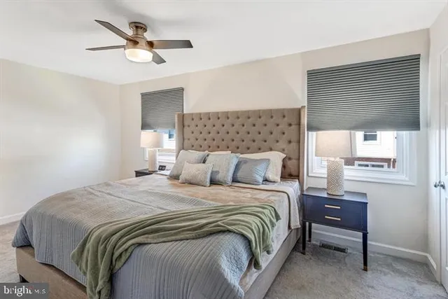 a bedroom with a bed a window and a chandelier