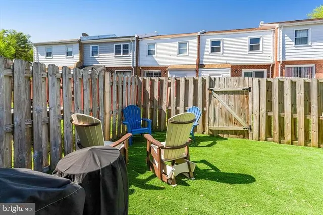 a view of a chair and table in backyard
