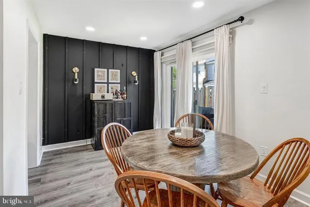 a dining room with furniture and wooden floor