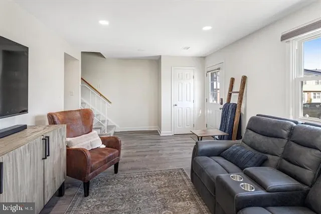 a living room with furniture and a flat screen tv