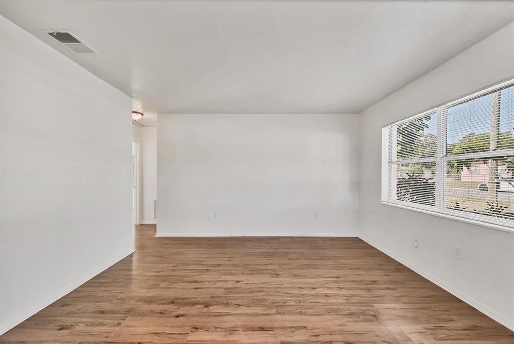 1622 29th Street Sarasota, FL 34234 - Photo 11 of 39 a view of an empty room with wooden floor and a window
