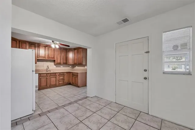 a kitchen with stainless steel appliances a refrigerator sink and cabinets
