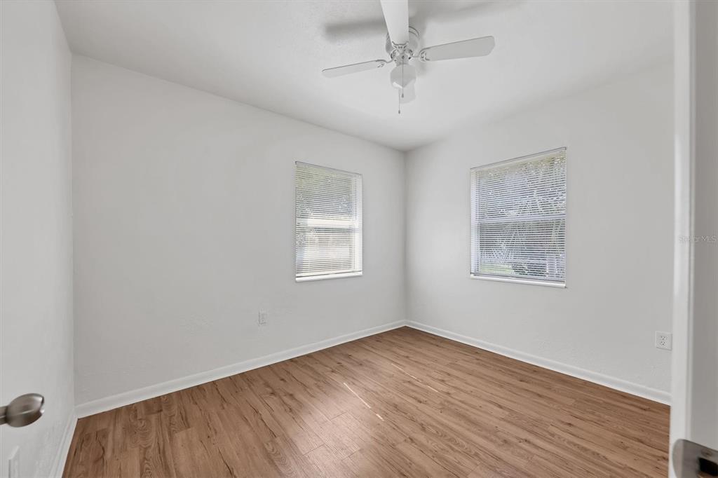 1622 29th Street Sarasota, FL 34234 - Photo 23 of 39 a view of empty room with wooden floor and fan