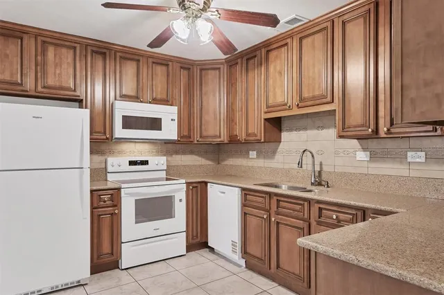 a kitchen with stainless steel appliances granite countertop a stove sink microwave and cabinets
