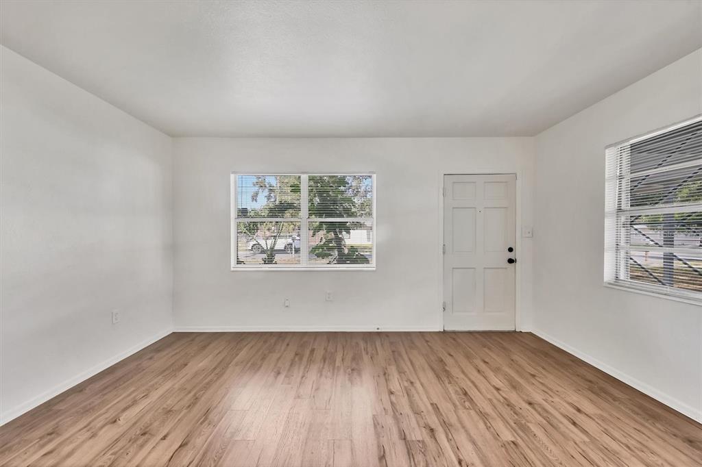 1622 29th Street Sarasota, FL 34234 - Photo 10 of 39 wooden floor in an empty room with a window