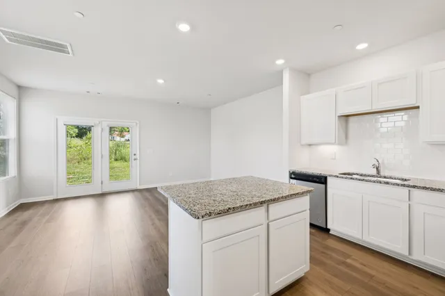 a kitchen with a sink stove and cabinets