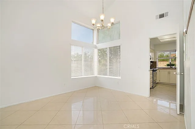 a view of an empty room with a kitchen