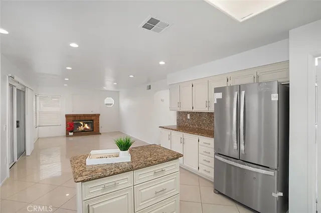a kitchen with granite countertop stainless steel appliances and counter space
