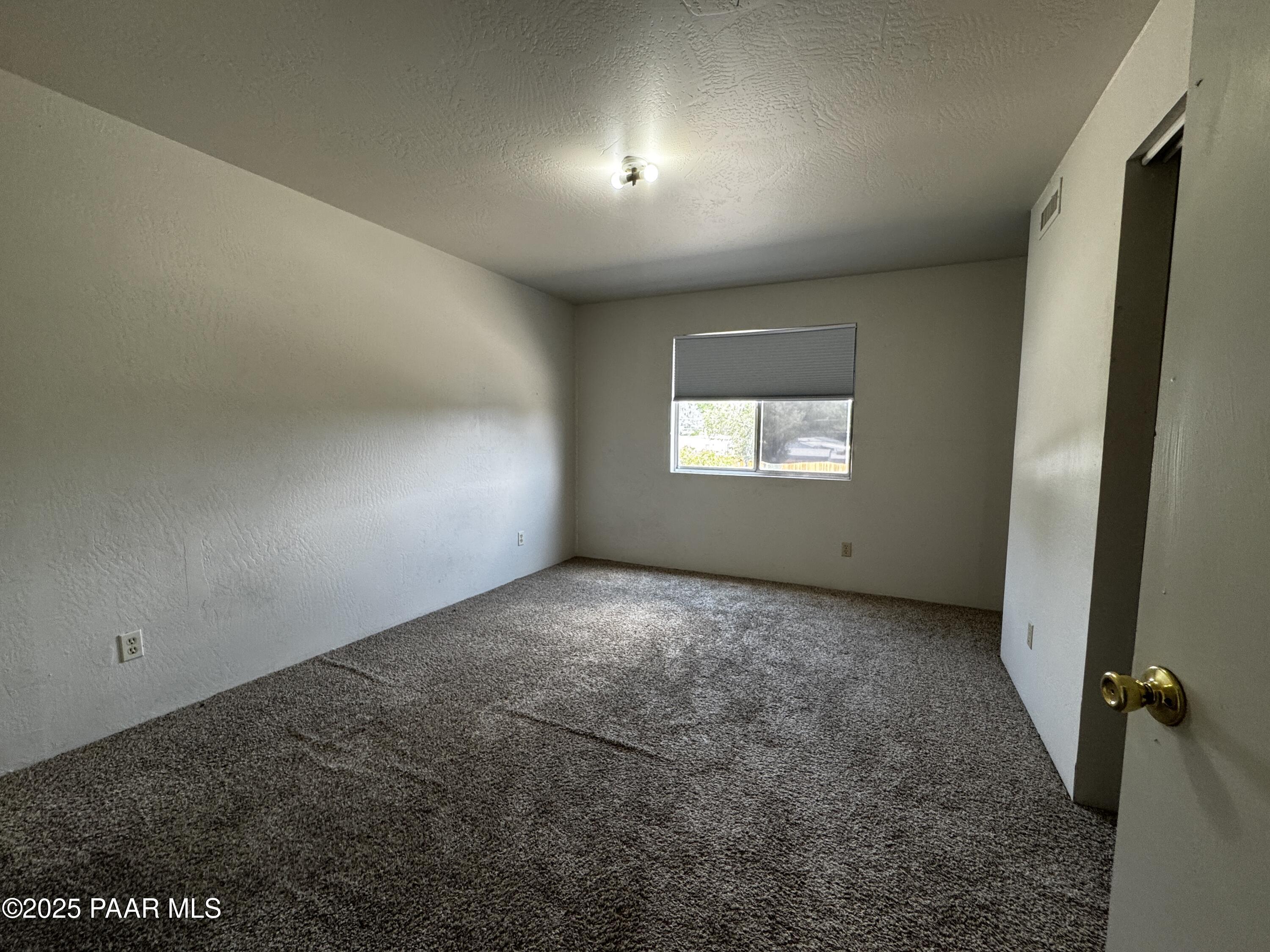 1022 Gail Gardner Way, Unit A Prescott, AZ 86305 - Photo 4 of 6 a view of an empty room and window