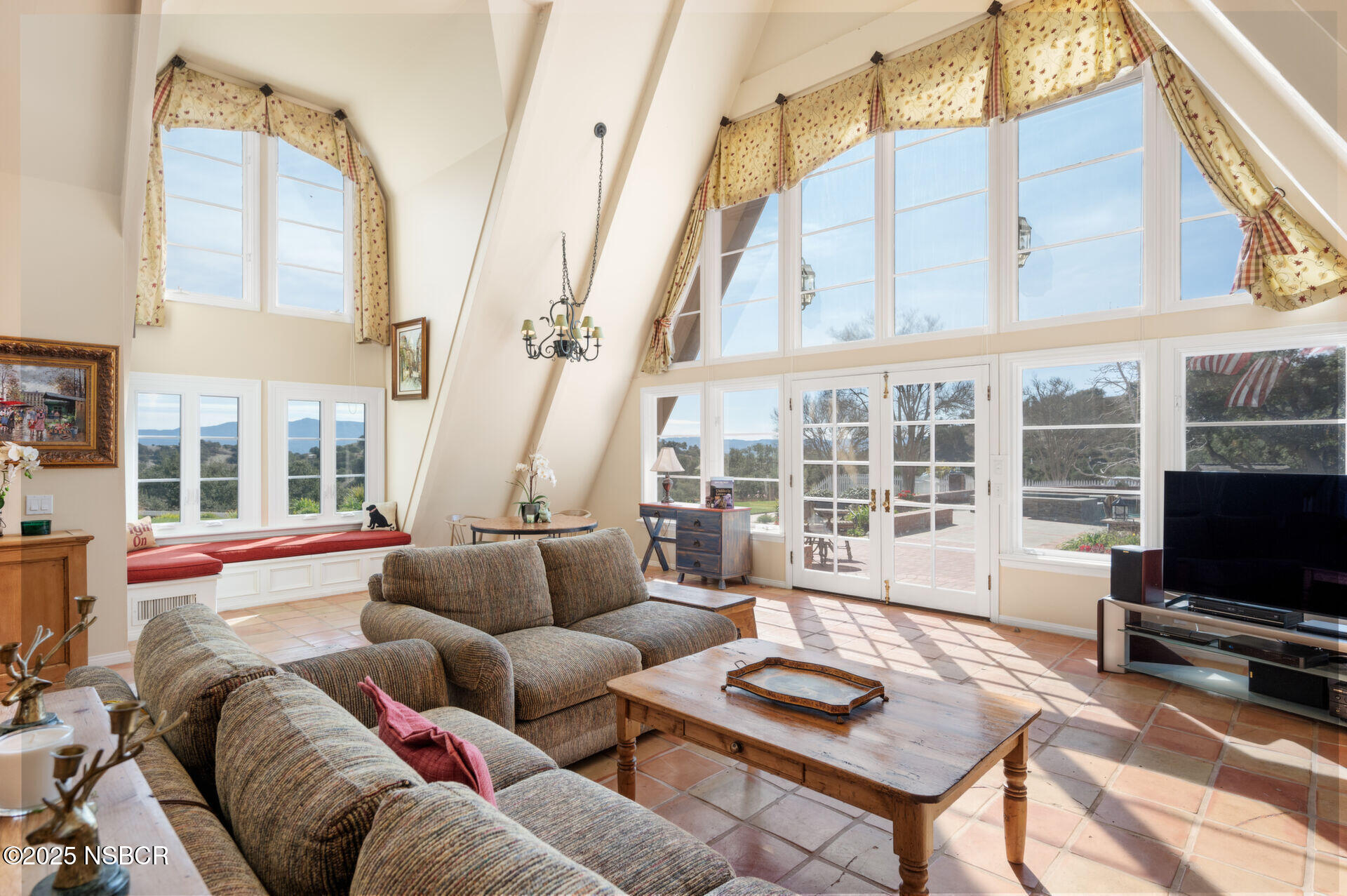 4086 East Oak Trail Road Santa Ynez, CA 93460 - Photo 12 of 57 a living room with furniture a flat screen tv and a large window