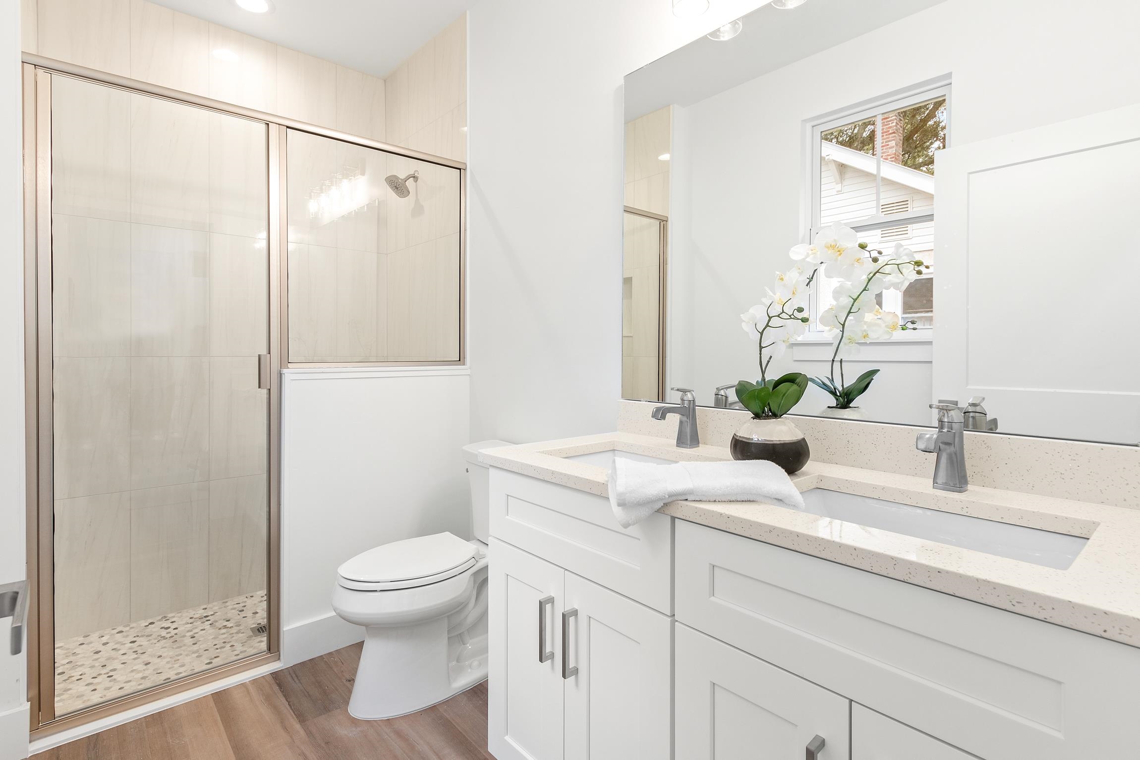 24 River Road St. Augustine, FL 32084 - Photo 16 of 26 a bathroom with a granite countertop sink a toilet and a shower