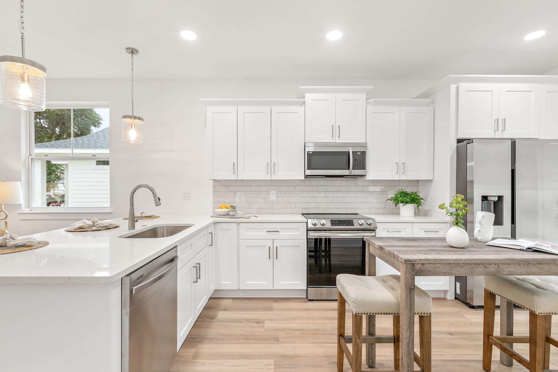 24 River Road St. Augustine, FL 32084 - Photo 10 of 26 a kitchen with a sink stove a refrigerator and white cabinets