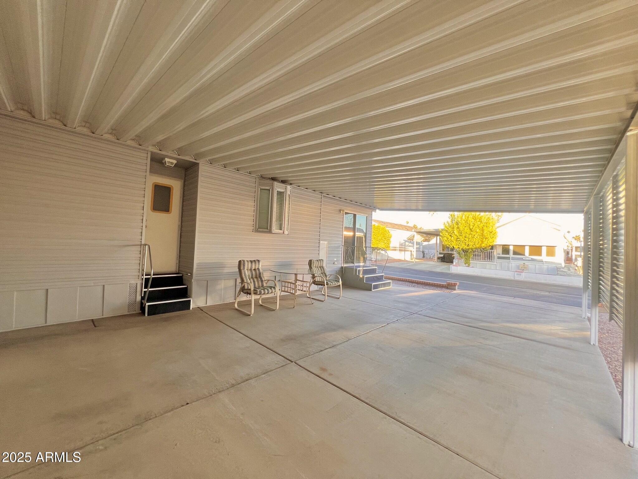111 South Greenfield Road, Unit 724 Mesa, AZ 85206 - Photo 11 of 23 a view of a patio with table and chairs under an umbrella