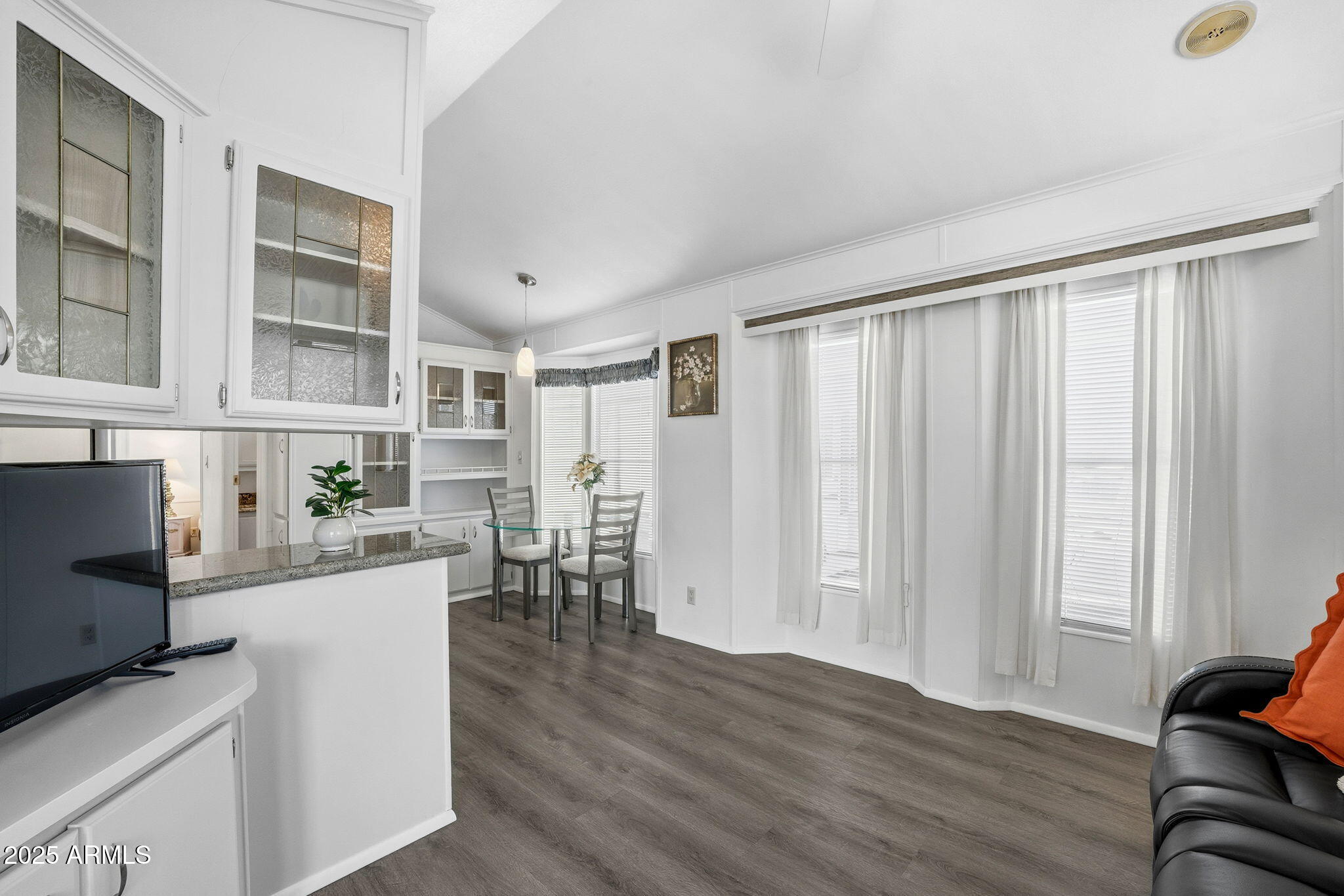 111 South Greenfield Road, Unit 724 Mesa, AZ 85206 - Photo 4 of 23 a view of a workspace with furniture and wooden floor