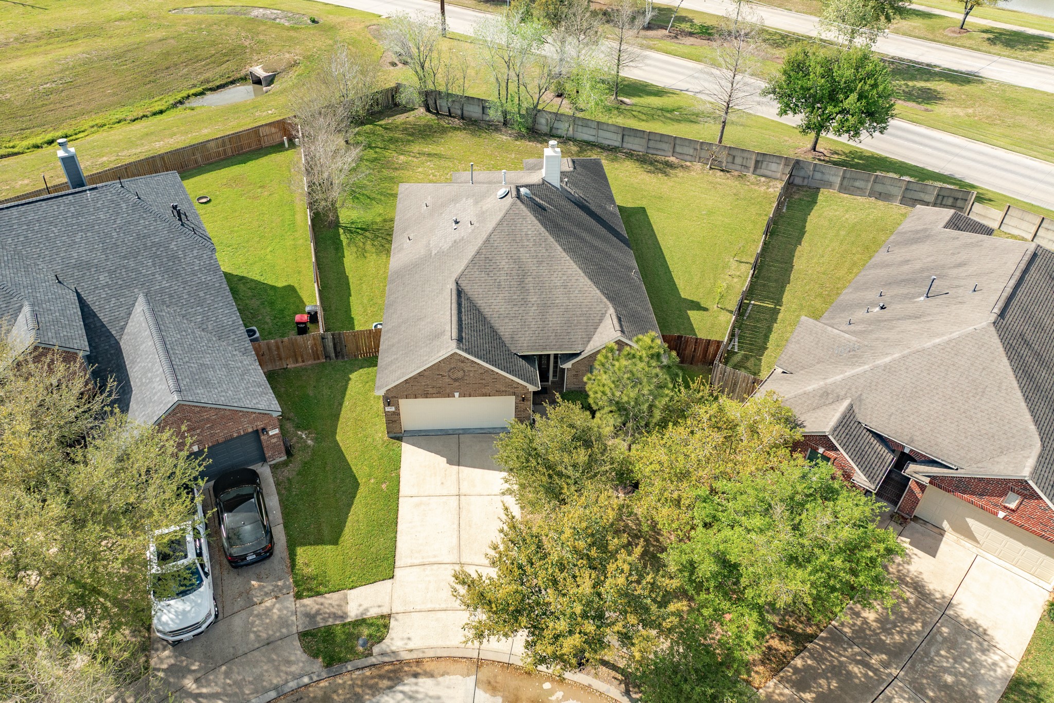 13417 Star Creek Lane Rosharon, TX 77583 - Photo 33 of 41 Aerial view of new home, showcasing the roof, yard, and double driveway.