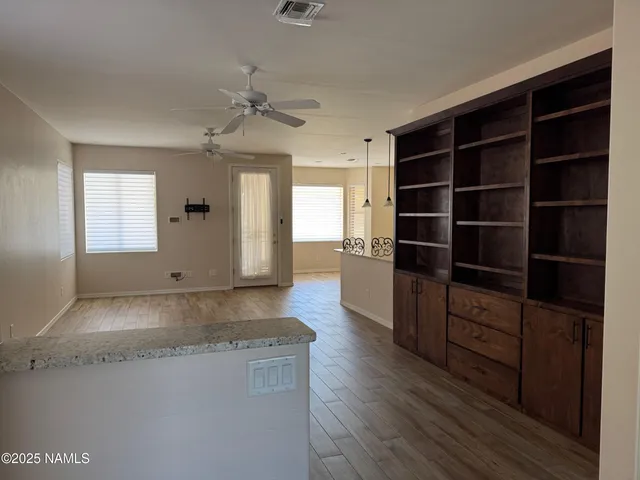 a living room with hard wood floors and a window