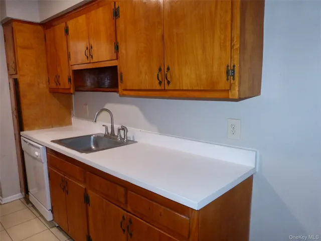 a kitchen with stainless steel appliances a sink dishwasher stove and microwave oven