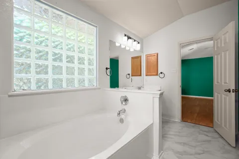 a bathroom with a bathtub and a sink